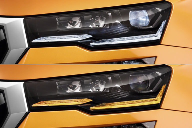 Die Scheinwerfer sind flacher gezeichnet und tragen jetzt einen Knick in der Unterkante, was zu einem geteilten Tagfahr- bzw. Blinklicht führt. Zusammen mit dem äußeren Knick wirkt das gelungen